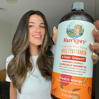 Customer holding MaryRuth Liquid Multivitamin + Hair Growth