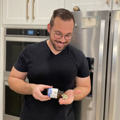 Greg holding product