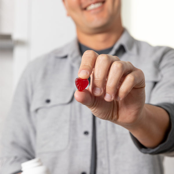 MaryRuth Biotin Gummies For Hair, Skin & Nails Goji Berry Flavor Product Photography - Man taking Gummy